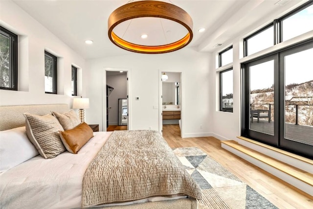 bedroom with connected bathroom, baseboards, wood finished floors, and recessed lighting