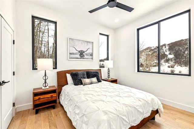 bedroom with ceiling fan, baseboards, hardwood / wood-style floors, and recessed lighting