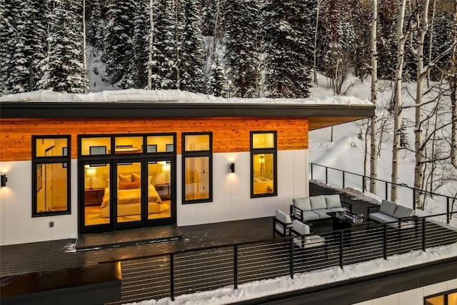 snow covered house with an outdoor hangout area