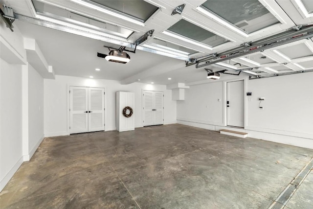 garage featuring a garage door opener and baseboards