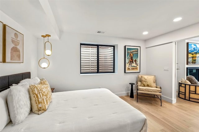 bedroom with baseboards, recessed lighting, visible vents, and light wood-style floors