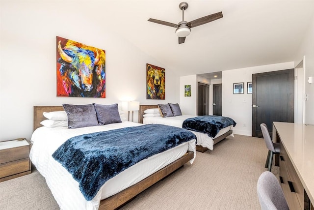 bedroom featuring light colored carpet, vaulted ceiling, and ceiling fan