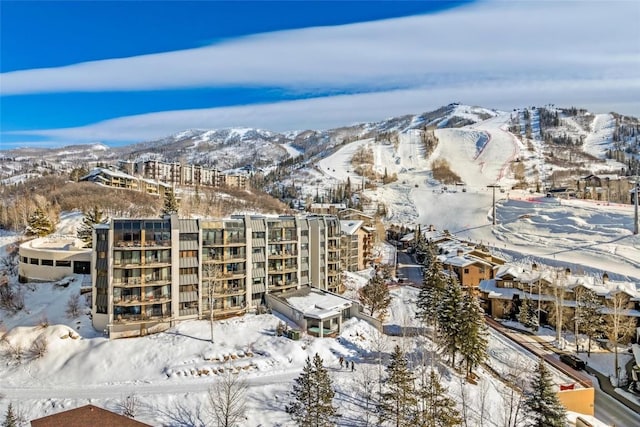 snowy aerial view featuring a mountain view