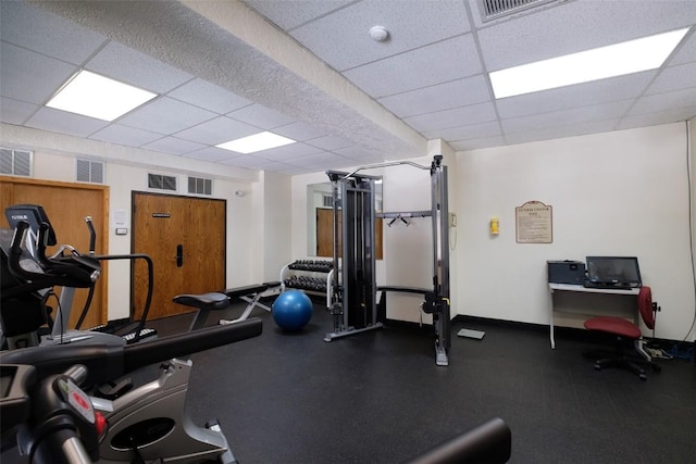 workout area featuring a drop ceiling