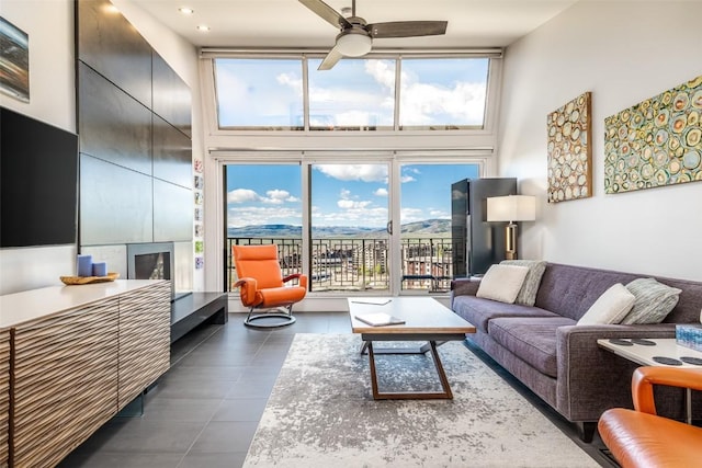 living room with a high ceiling and ceiling fan