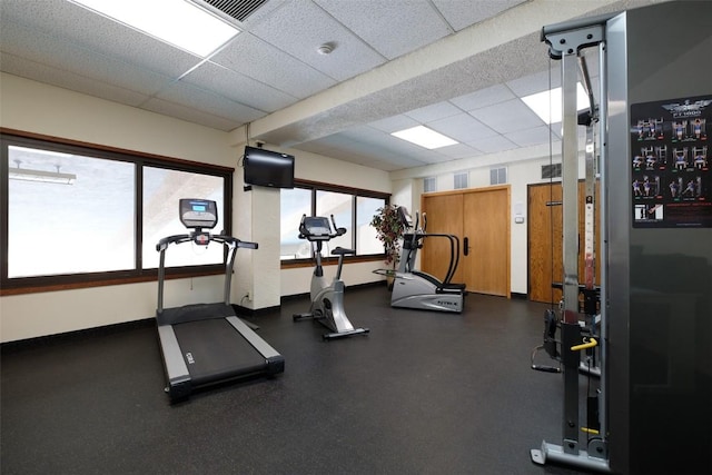 exercise room featuring a drop ceiling