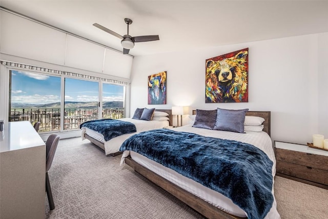 bedroom with carpet, vaulted ceiling, ceiling fan, and access to outside