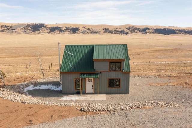 view of outbuilding featuring a mountain view and a rural view