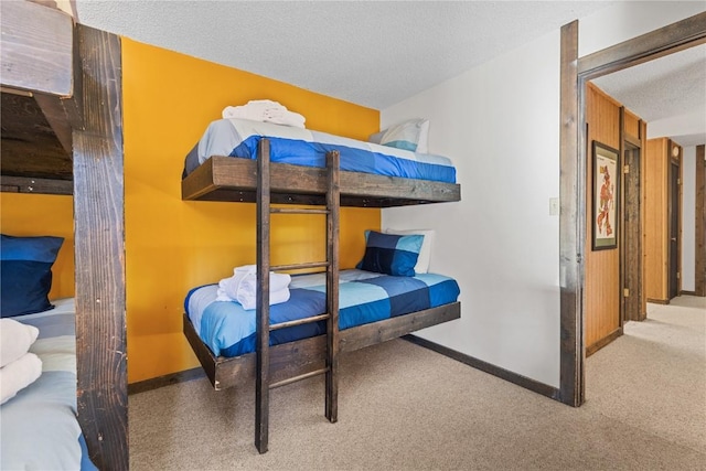 bedroom with a textured ceiling and carpet