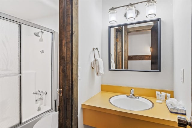 bathroom with shower / bath combination with glass door and vanity