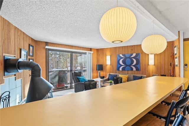 home office with wood walls and a textured ceiling