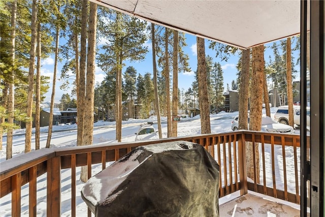 snow covered deck featuring grilling area