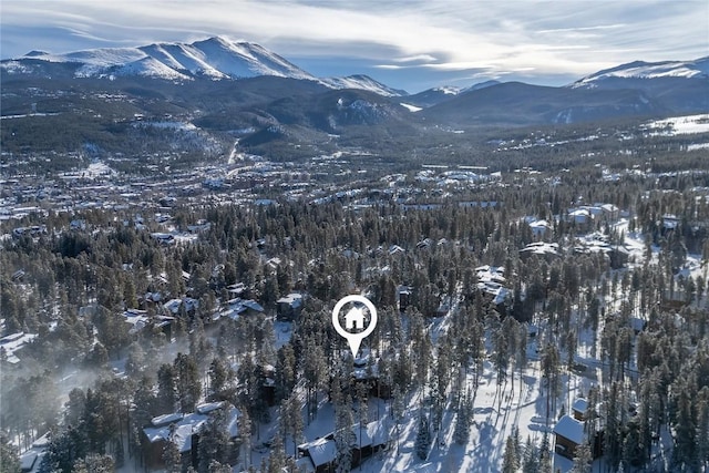 snowy aerial view with a mountain view