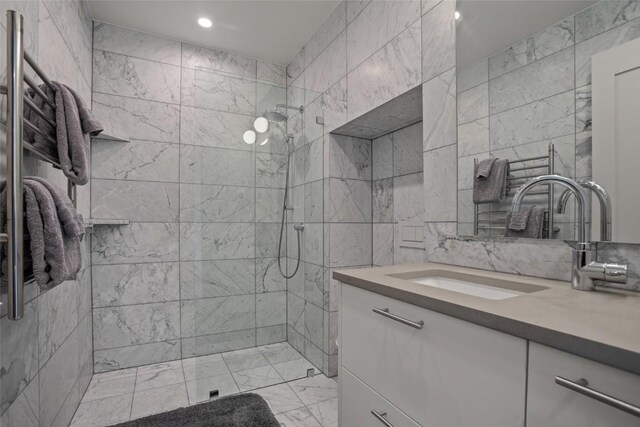 bathroom featuring vanity, tile walls, and tiled shower