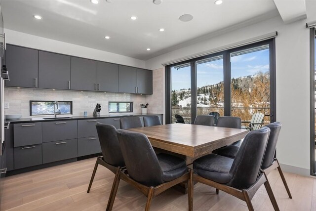 dining room featuring sink and light hardwood / wood-style floors