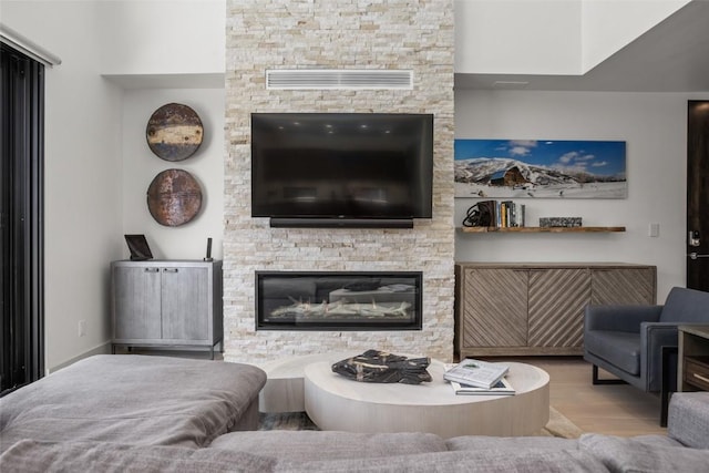 living room with light hardwood / wood-style floors and a fireplace