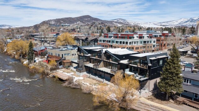 drone / aerial view with a water and mountain view