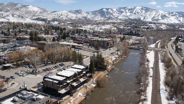 snowy aerial view with a mountain view