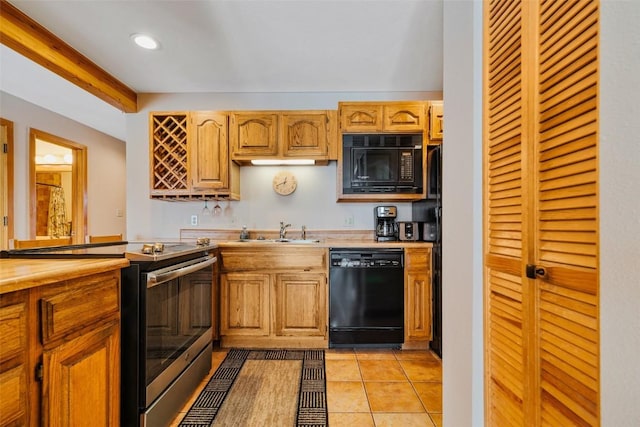 kitchen with light tile patterned flooring, sink, and black appliances