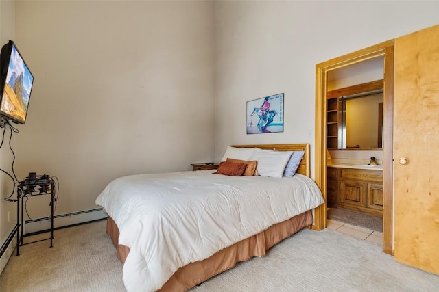 bedroom with light carpet, connected bathroom, and a baseboard radiator