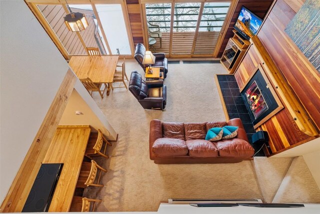 carpeted living room with a tiled fireplace