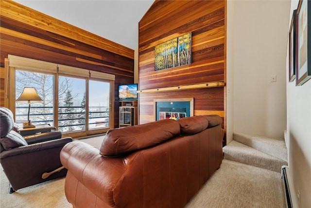 living room with light colored carpet, vaulted ceiling, baseboard heating, and wood walls