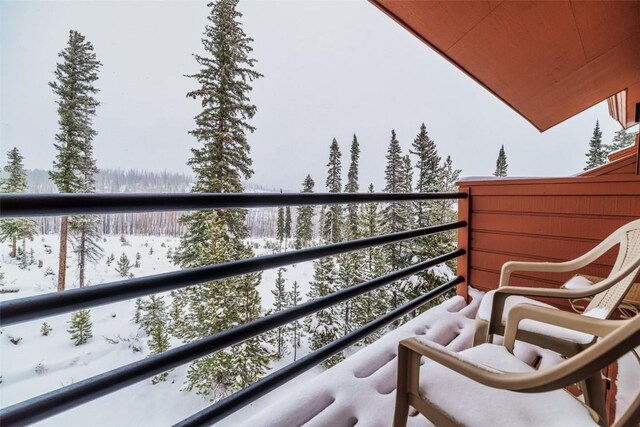 view of snow covered back of property