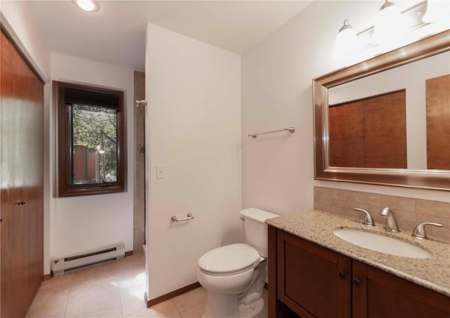 bathroom with vanity, backsplash, a baseboard heating unit, tile patterned flooring, and toilet