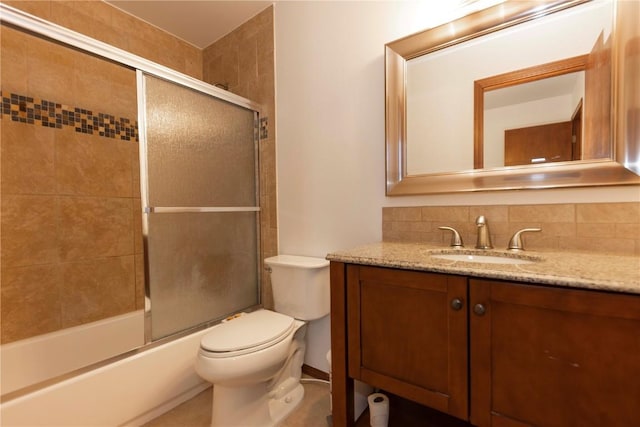 full bathroom with vanity, toilet, combined bath / shower with glass door, and backsplash