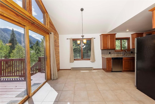 kitchen with stainless steel appliances, backsplash, a mountain view, pendant lighting, and light tile patterned flooring