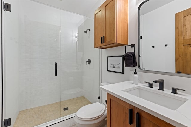 bathroom with vanity, toilet, and walk in shower