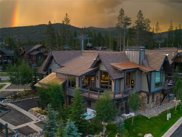 view of back house at dusk