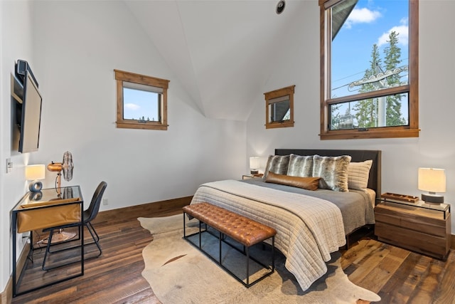 bedroom featuring dark hardwood / wood-style flooring and vaulted ceiling