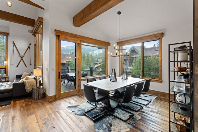 dining area featuring beamed ceiling, hardwood / wood-style floors, and an inviting chandelier