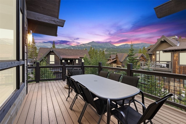 deck at dusk featuring a mountain view