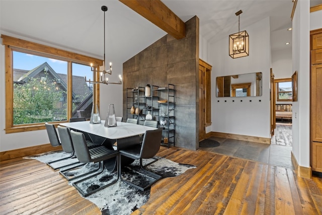 dining area with beamed ceiling, dark hardwood / wood-style flooring, high vaulted ceiling, and an inviting chandelier