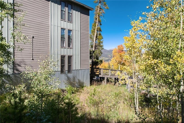 view of side of property with a deck with mountain view