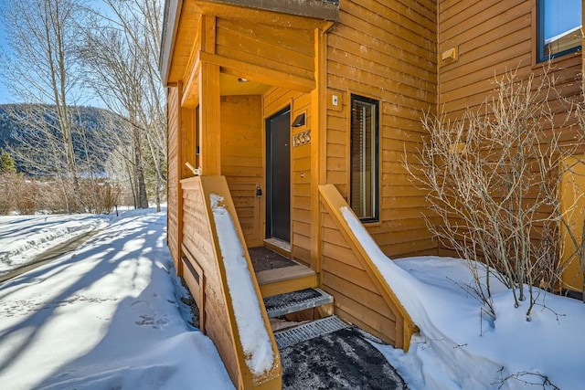 view of snow covered property entrance