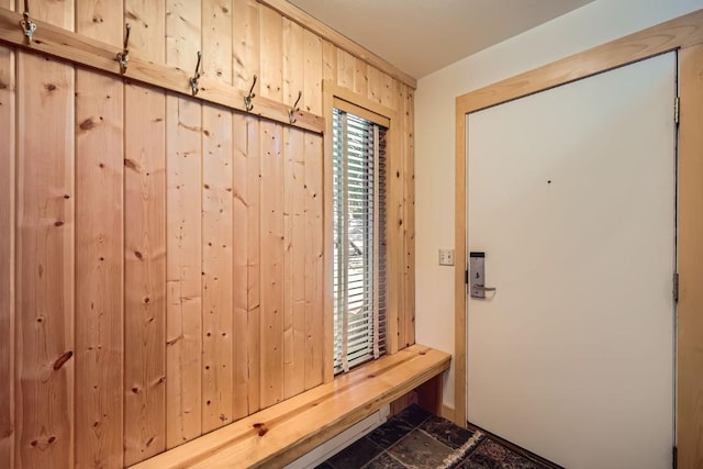 mudroom with wooden walls