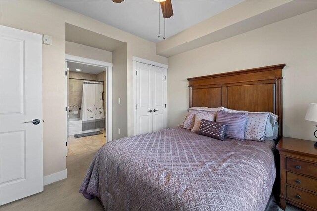 carpeted bedroom featuring connected bathroom, a closet, and ceiling fan