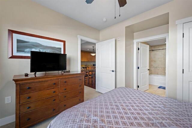 bedroom with ensuite bath and ceiling fan