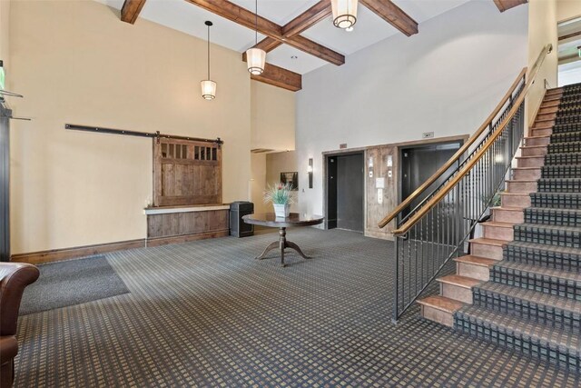 interior space with carpet flooring, coffered ceiling, a barn door, beamed ceiling, and elevator