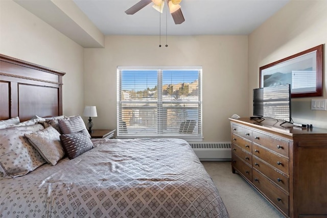 bedroom featuring ceiling fan, light carpet, and radiator