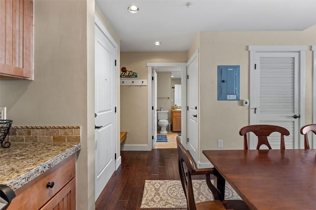 dining space with electric panel and dark hardwood / wood-style floors