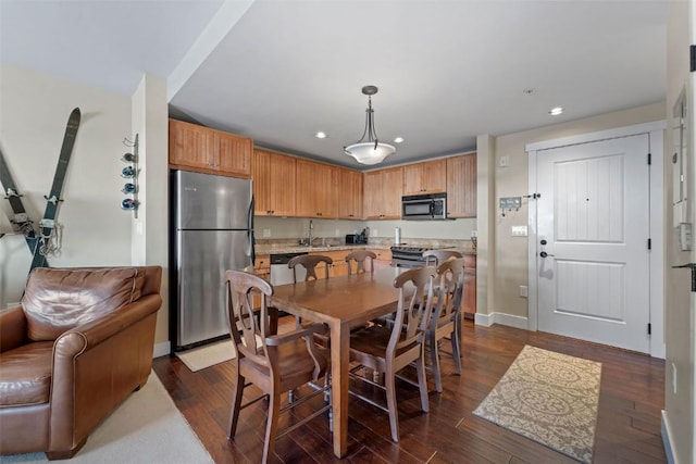 dining area featuring dark wood-type flooring and sink