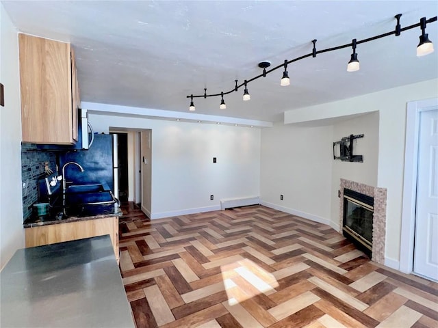 living room featuring sink, parquet flooring, and a high end fireplace