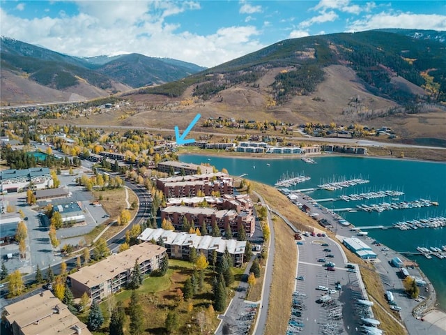 drone / aerial view featuring a water and mountain view