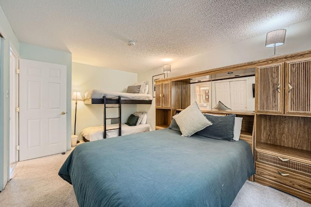 carpeted bedroom featuring a textured ceiling