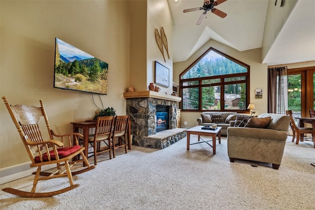 living room featuring a fireplace, ceiling fan, high vaulted ceiling, and carpet