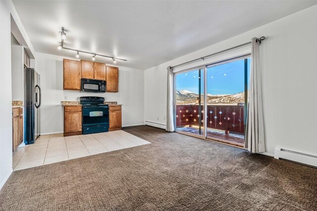 kitchen with light colored carpet, a baseboard radiator, and black appliances